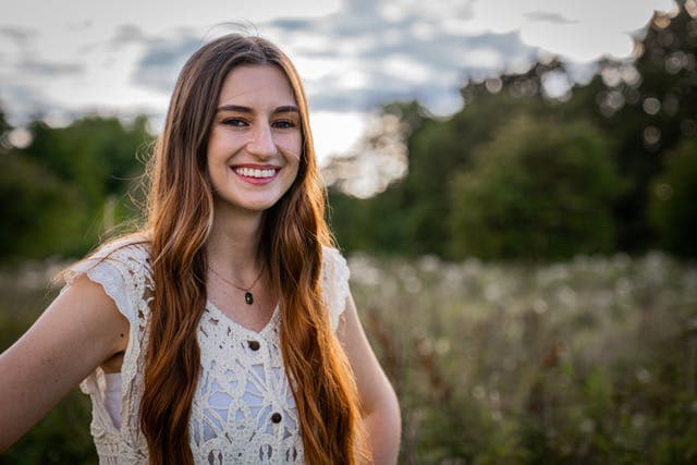 Dr cloie portrait with sky and fields behind her