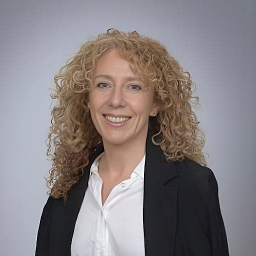 Marina Edelman Looking forward with white blouse and black jacket